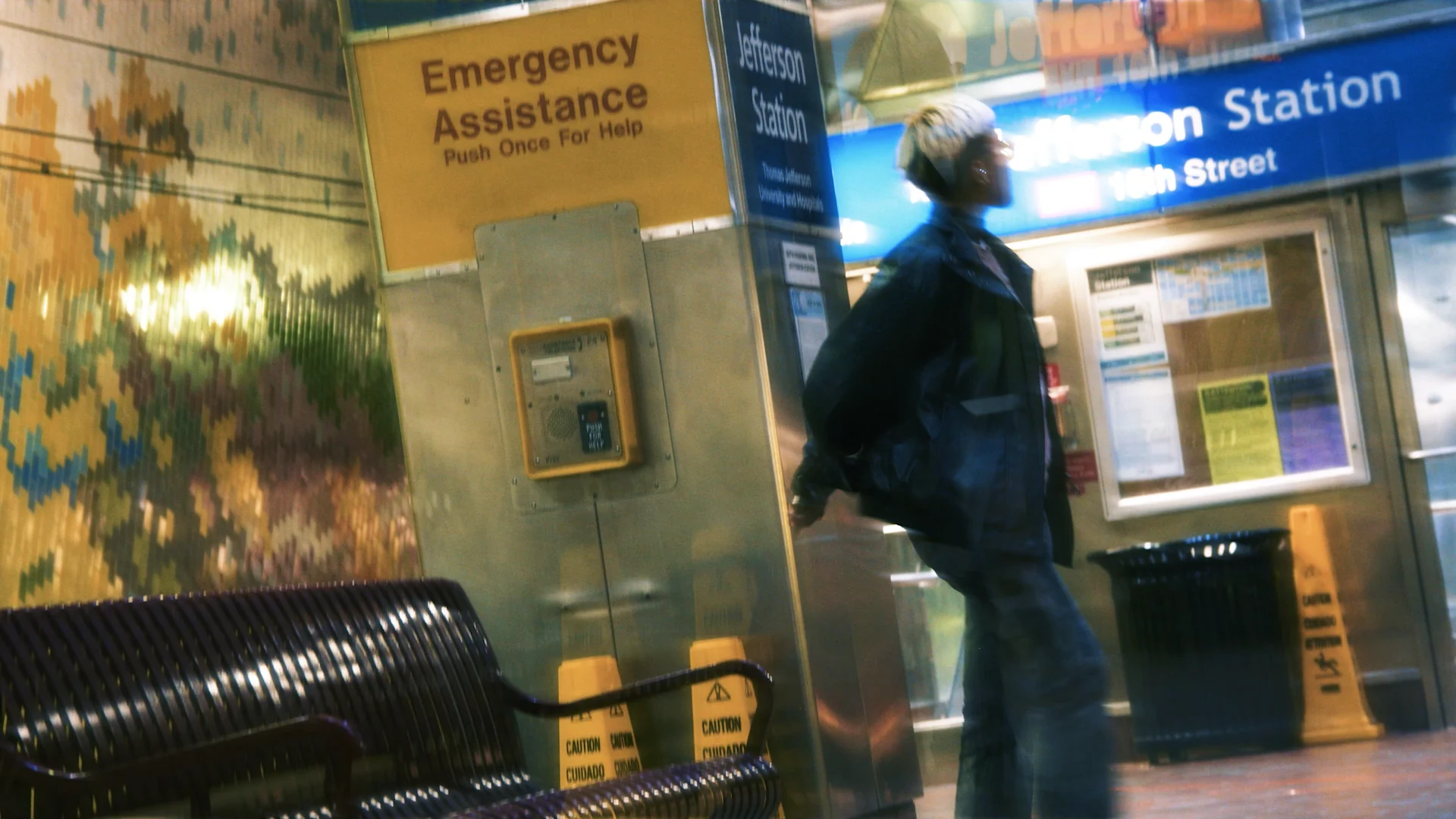 A figure moving through a subway station