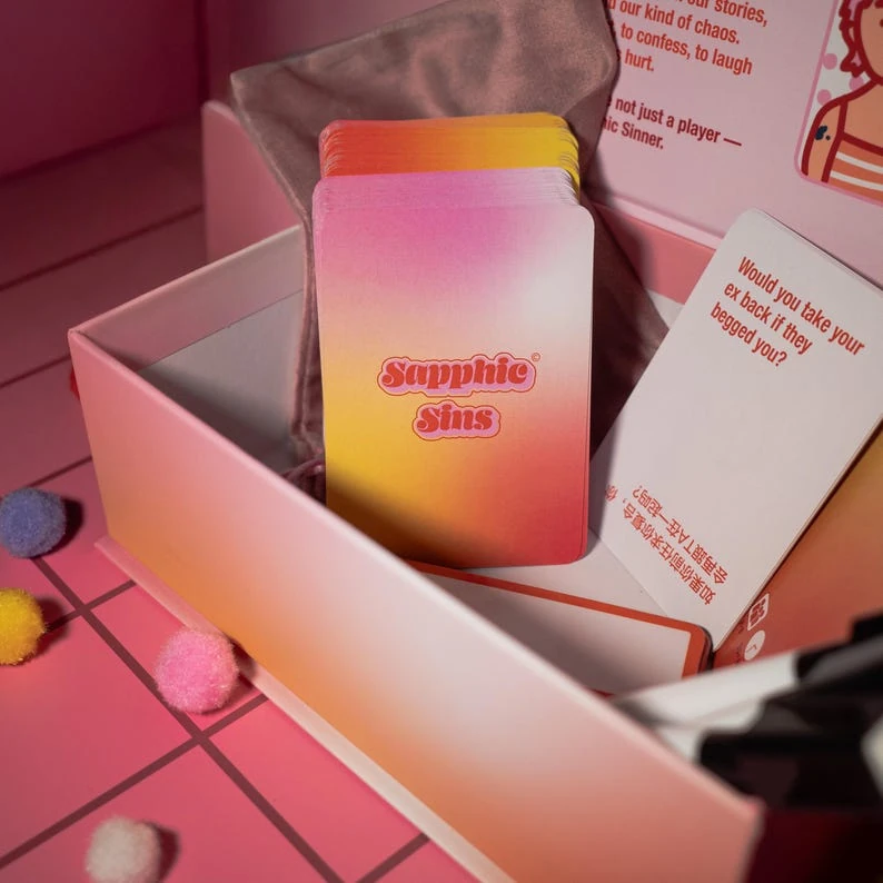 Sapphic Sins card deck inside the open game box