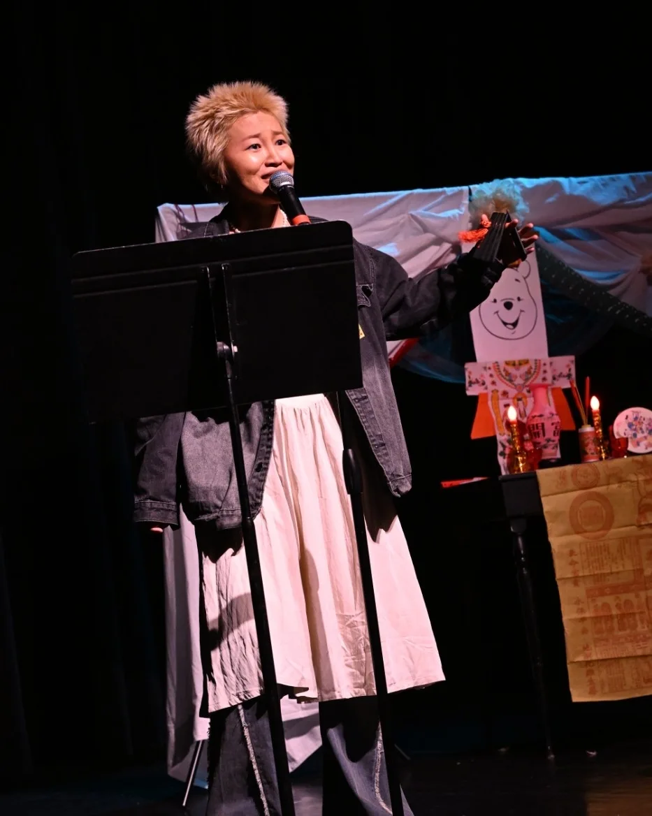 Raw ABEI extending an arm during an expressive stage performance